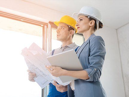 Bauplaner mit Plänen in der Wohnung